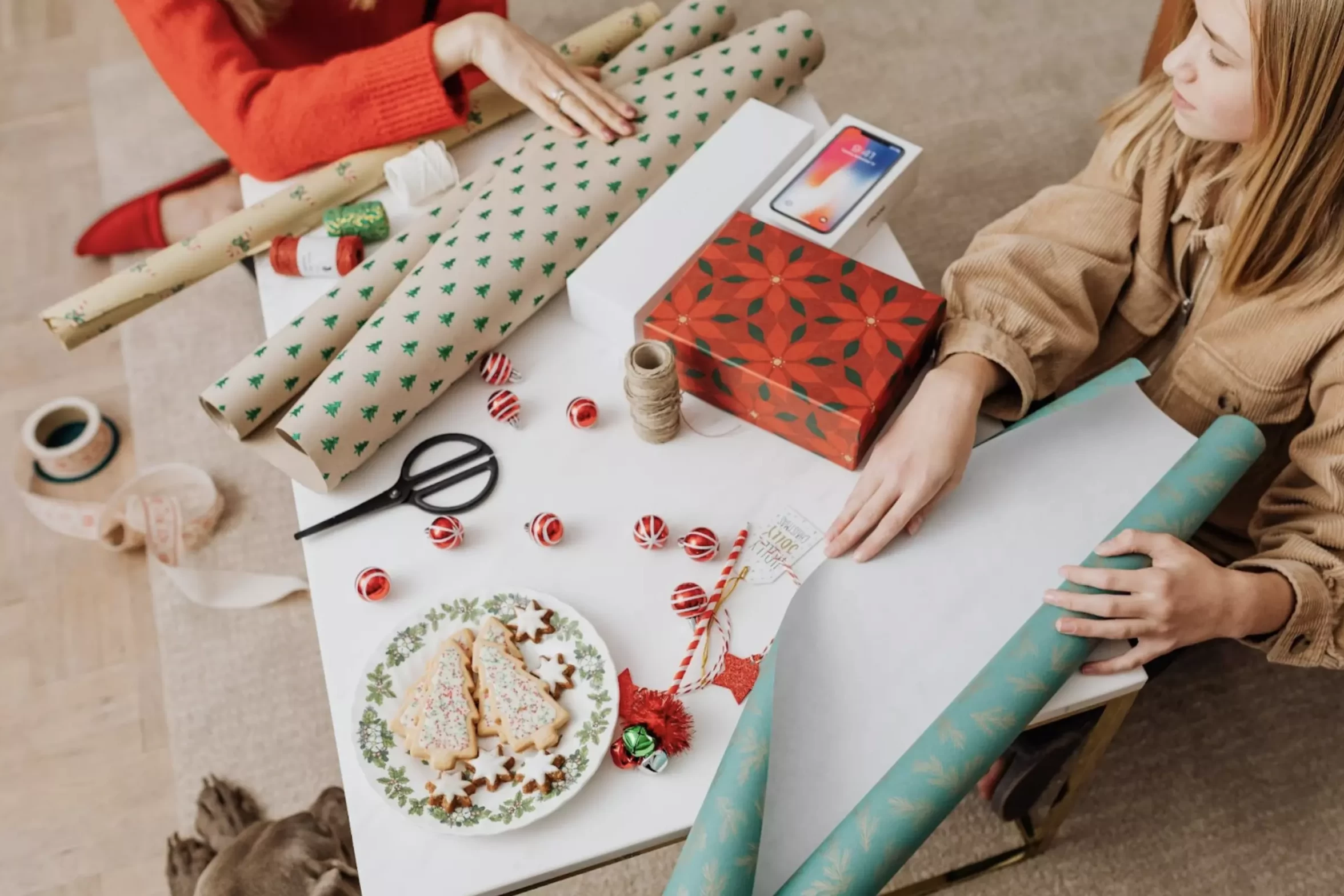 women wrapping holiday presents
